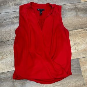 Red sleeveless blouse, size large.